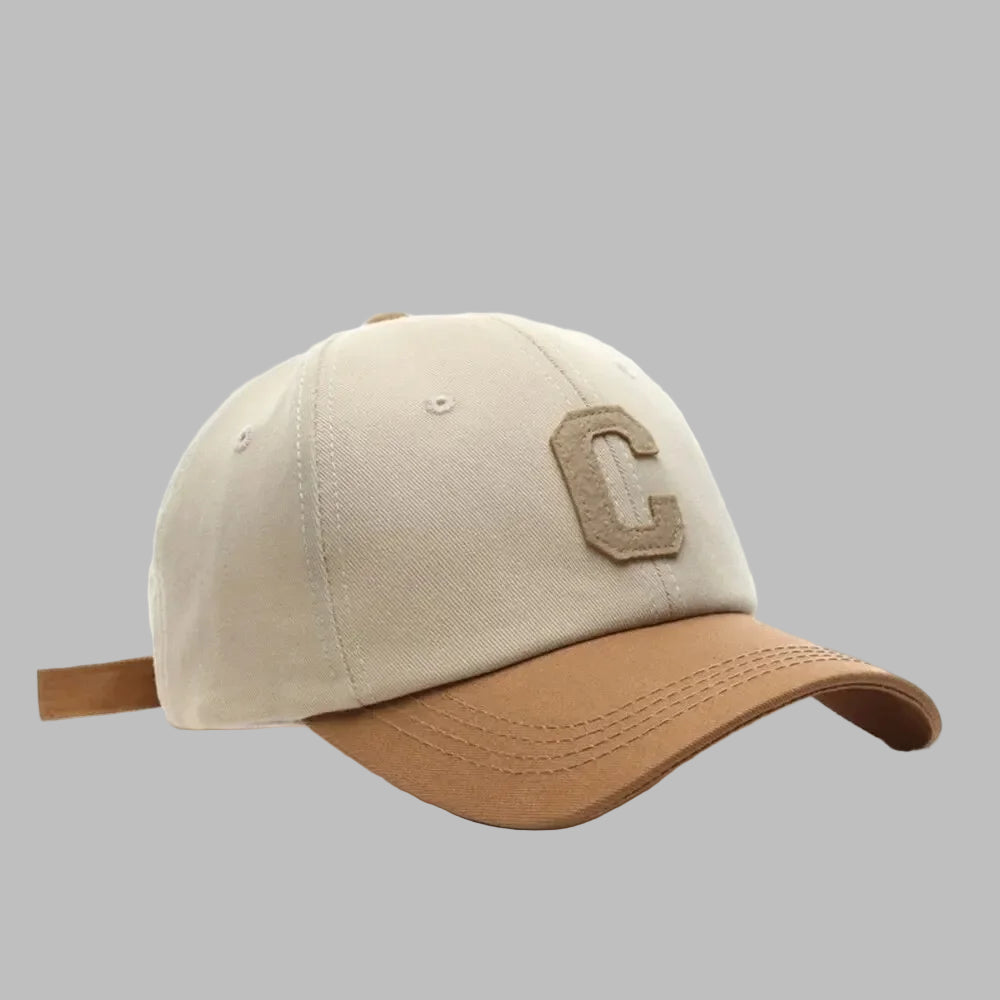 Beige and brown baseball cap with a logo on a white background