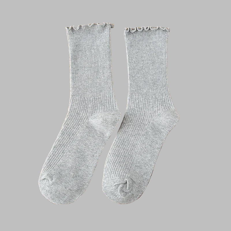 Pair of gray socks on a wooden surface