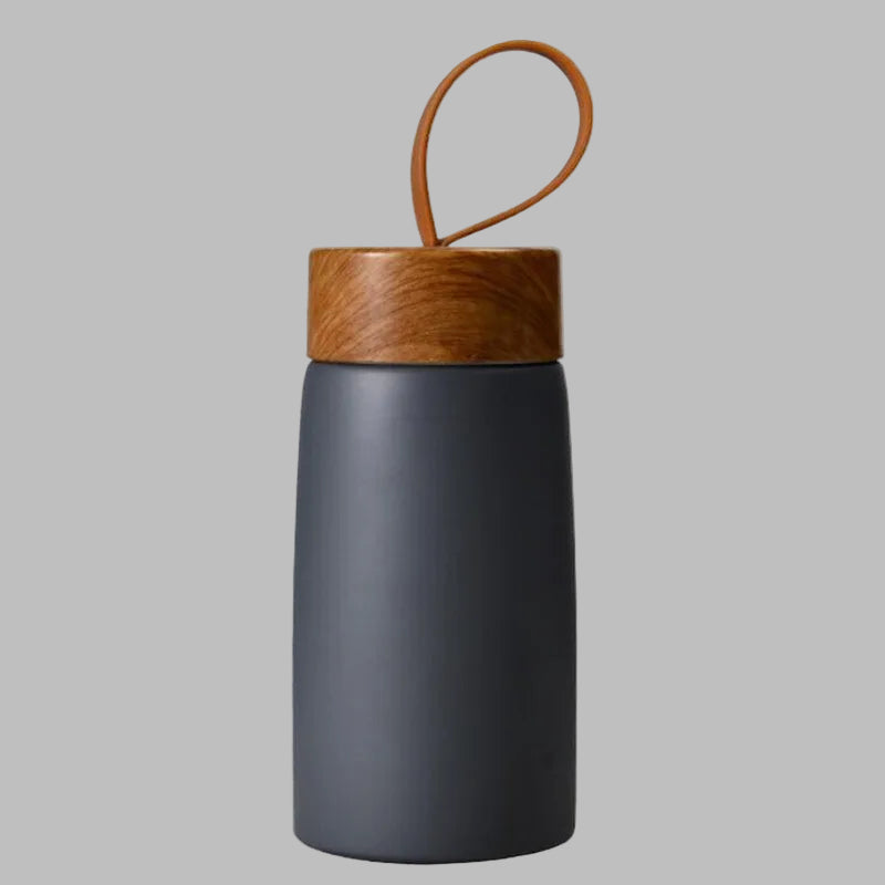 Dark gray water bottle with a wooden lid on a white background