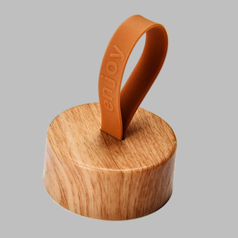 Wooden container lid with a brown rubber gasket on a white background